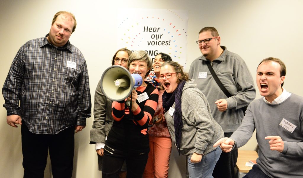 Group of people screaming into megaphone (from Hear our voices! 2017)