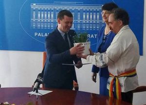 The "Forget-me-not" flower is handed over by Mircea-Valer Pauca, a person with High-functioning autism